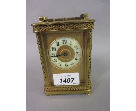 Small early 20th Century gilt brass carriage clock, the floral decorated case with enamel dial, Arabic numerals and single tr