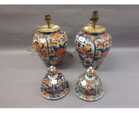 Pair of 19th Century Imari ovoid jars with covers decorated in conventional iron red and blue (the covers removed, the bases 