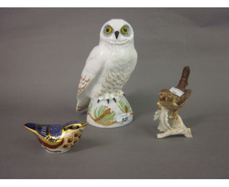 Royal Crown Derby paperweight in the form of a nuthatch, Crown Staffordshire figure of a snowy owl and a Goebel figure of a w