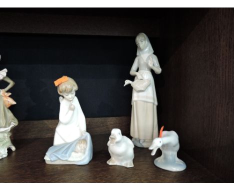 Four Lladro, Nao and Valencia figurines and studies, Angel with child, Girl with duck and two ducklings