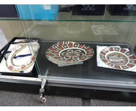 Four Royal Crown Derby Imari plates including Millennium Dove along with two Royal Crown Derby ceramic horse shoes, some boxe