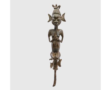copper alloy and iron, the figure shown kneeling, wearing a cap topped with a bird finial, holding his long beard in clasped 