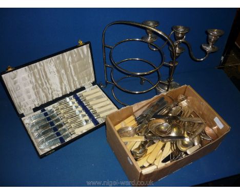 A Walker &amp; Hall plated cake stand, silver plated candelabra and mixed box of cutlery.