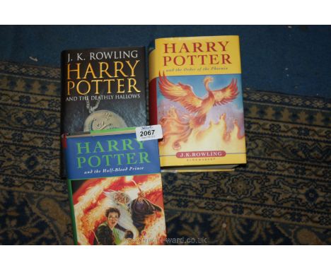 Three First Edition Harry Potter books.