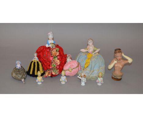 10 ceramic pin cushion ladies, some with legs.