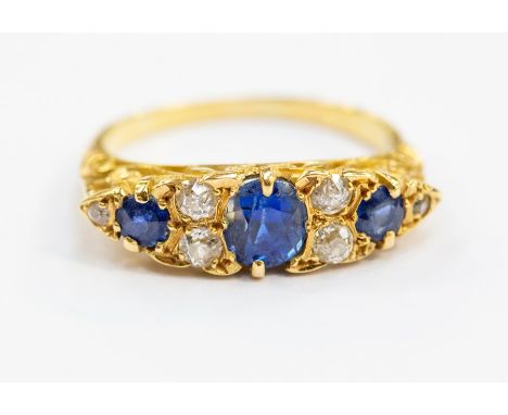 A Victorian and sapphire boat head ring 18ct gold, comprising a oval sapphire to the centre with two further round cut sapphi