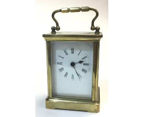 A brass carriage clock, bearing white enamel dial and Roman numerals, no makers marks, height approx. 14cm, working order, ho