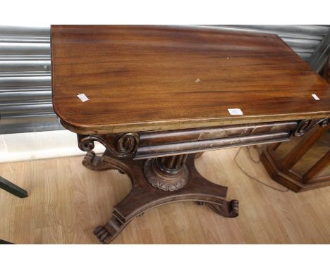 A William iV mahogany folding card table Circa 1830,opening top to a green rectangular playing surface ,above scrolled carvin