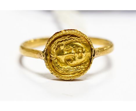 A Greek gold signet ring, circa 3rd Century, the gold disc front with the head of Apollo to both sides, ring size S½, gross w