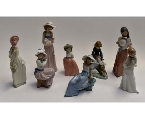 A collection of eight Nao figurines to include: various seated and standing figures. (8)