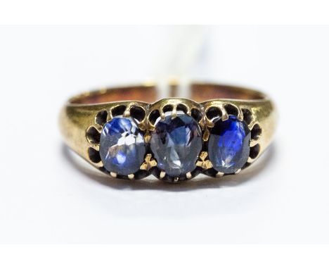 A yellow metal and sapphire three stone ring, size N, total gross weight approx 4.5gms