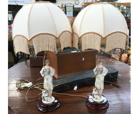 Two Capodimmte bisque figures of a 1920s woman with two terriers, on lamp base retailed by Giuseppe Armani Florence with shad
