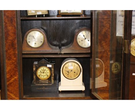 A late 19th Century, slate mantle clock, bearing Roman numerals; together with three early-mid 20th Century mantle clocks, al