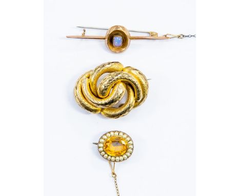 Three brooches to include a paste set brooch with seed pearl surround, unmarked yellow metal along with a opal set bar brooch