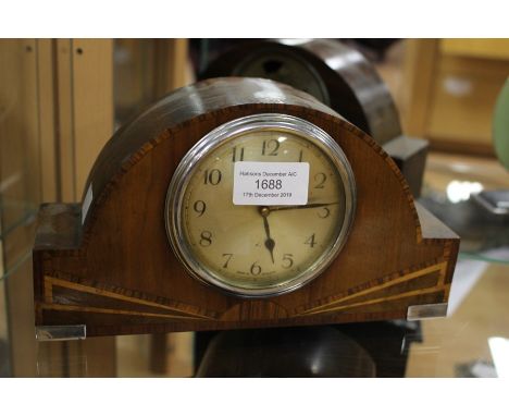 A 1930's, 8 day mantle clock, possibly Art Deco, the veneered case inlaid with sunbeam decoration and white metal mounts, hei