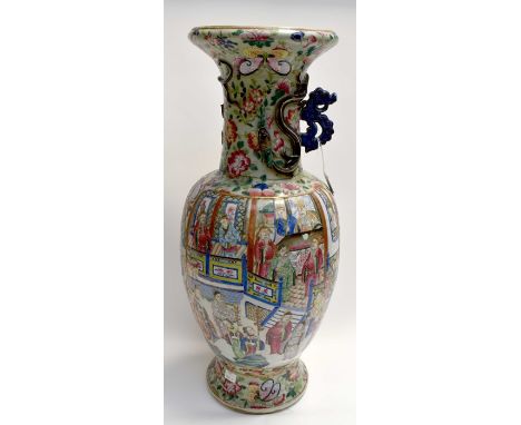 A Famille Rose Canton vase depicting interior scenes of important family, chrysanthemums, butterflies, peacock, applied chi l