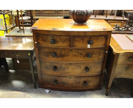 A Victorian mahogany bow front chest of drawers, two short and three long drawers