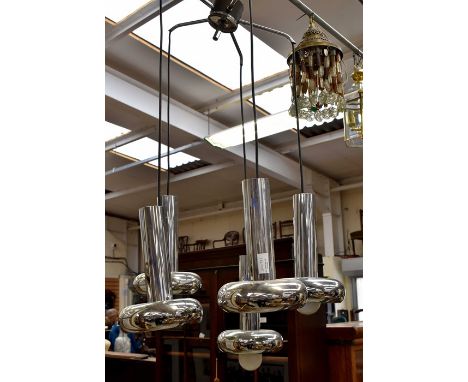A modern chrome hanging light fitting with four branches