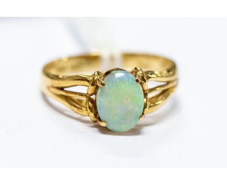 An 18ct gold and opal single stone dress ring, size L 1/2, 3.7 grams approx