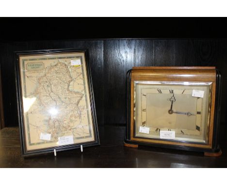 A 1930's Elliott mantle clock; together with a framed Staffordshire map, dated 1847, Johnson. (2)