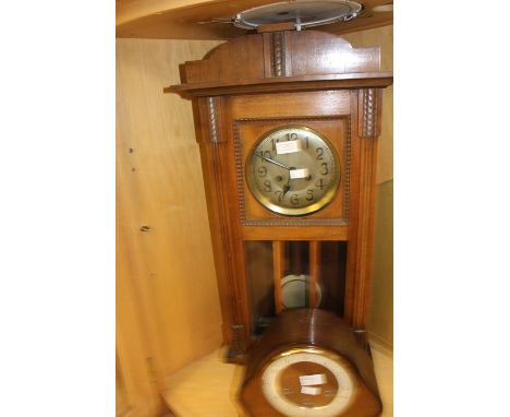 A mid-20th century wall clock, complete with pendulum; together with a 1930's mantle clock, Arabic numerals. (2)