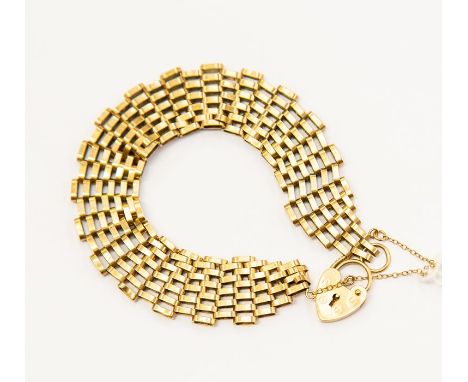 A 9ct gold six bar gate bracelet, brick style links, padlock clasp, weight approx. 10.7 grams