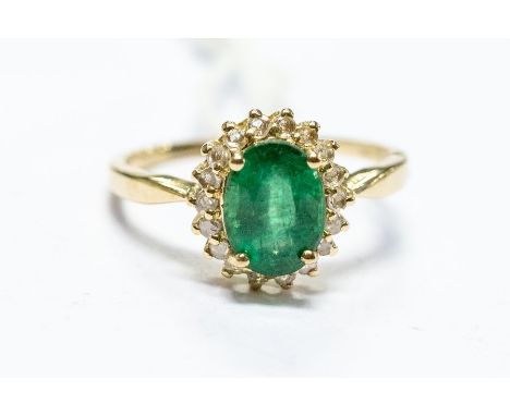 A 9ct gold, emerald and diamond cluster ring, the oval cut emerald approx 8.07 mm x 5.92 x 4.53, size J1/2, total gross weigh