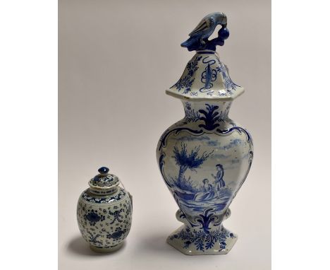 Two blue and white tin glaze items comprising: a large pot and cover showing a couple in a garden, the cover having a bird fi