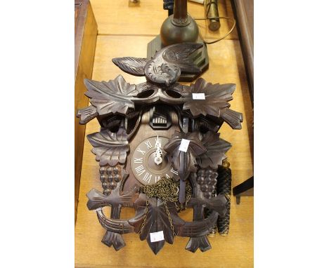 A late 20th Century, wall hanging cuckoo clock, appears to be in working order, Roman numerals, complete with weights, height