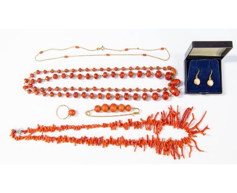 A collection of coral jewellery to include a faceted coral bead and unmarked yellow metal chain necklace, a coral bead and un