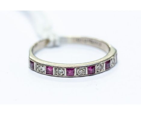 An 18ct white gold diamond and ruby half eternity ring, set with six calibre-cut rubies, with diamond inter spacers, ring siz