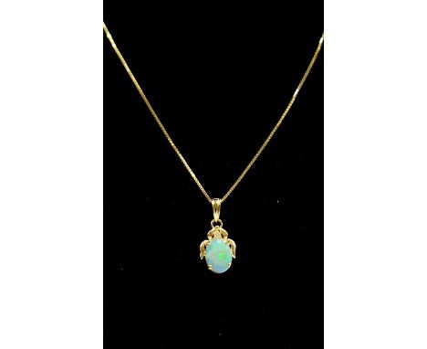 An 18ct gold fine link chain with a 14kt gold surround opal