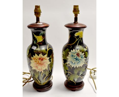 A pair of Japanese style 20th century lamp bases with floral decoration on a black ground, height approx. 43cm. (2)