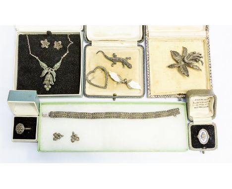 A collection of marcasite jewellery to include a silver and guilloche enamel ring with marcasite decoration, various brooches