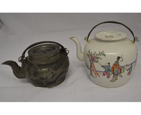 Two kettle pots, one in ceramic, depicting an Oriental scene of figures picking flowers and berries from a tree, height appro