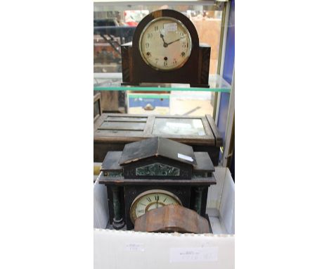 A wall clock, and three mantle clocks in need of restoration.