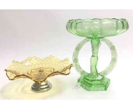 Two glass table centrepieces, green glass tazza, figural centre stem with round surround and removable bowl, pale brown cake 