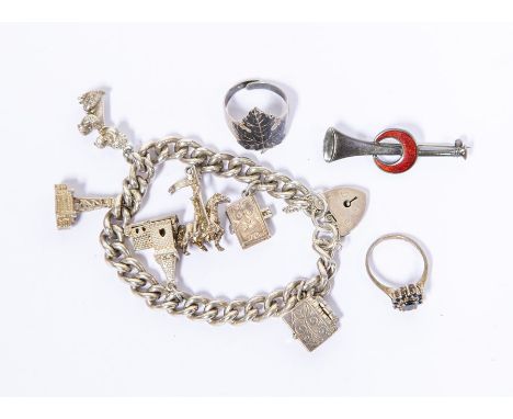 A Siamese silver ring; a silver ring; a Birmingham 1976 silver enamel brooch along with a silver charm bracelet&nbsp;