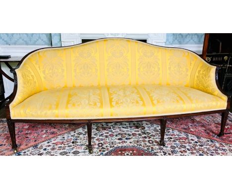 A Regency mahogany and later damask upholstered sofa, circa 1800, serpentine shape top with scrolling foliage arms, raised on