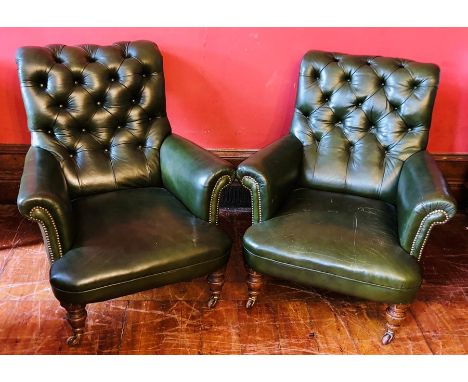 A pair of Victorian oak framed gentleman's library armchairs, circa 1870, green button back studded leather upholstery, scrol