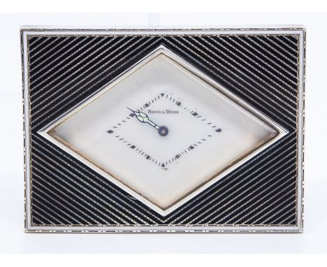 A French Art Deco Mappin & Webb retailed white metal desk or bedside easel timepiece, of rectangular form with a lozenge shap