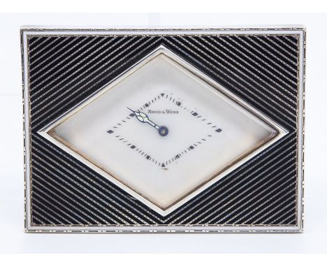 A French Art Deco Mappin & Webb retailed white metal desk or bedside easel timepiece, of rectangular form with a lozenge shap