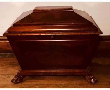 A Regency mahogany sarcophagus shaped cellarette, circa 1810, hinged cover top, on panel front and sides, sides fitted with c