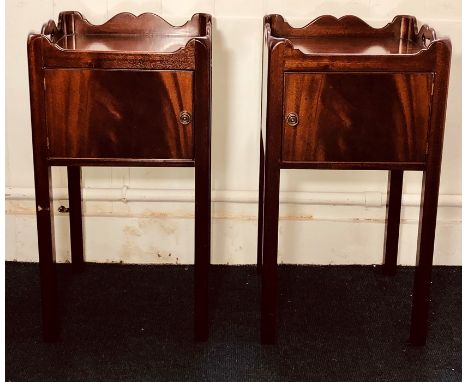 A pair of George III revival mahogany bedside commodes, gallery carved top above a single panel door, raised on fluted suppor