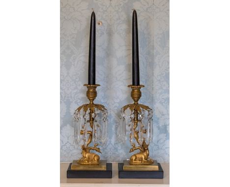 A pair of 19th Century gilt metal candelabra, modelled as a recumbent stag and doe beside a tree, detachable bobeches, the br