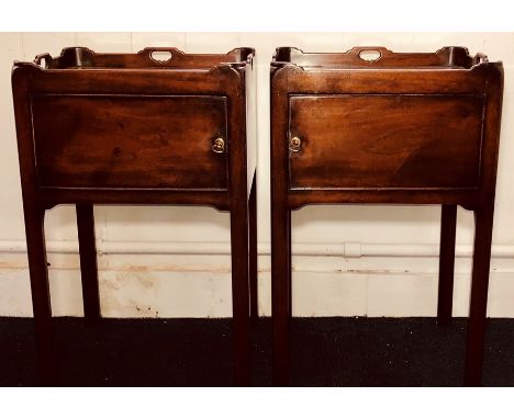 A pair of George III revival mahogany bedside commodes, gallery carved top above a single panel door, raised on fluted suppor
