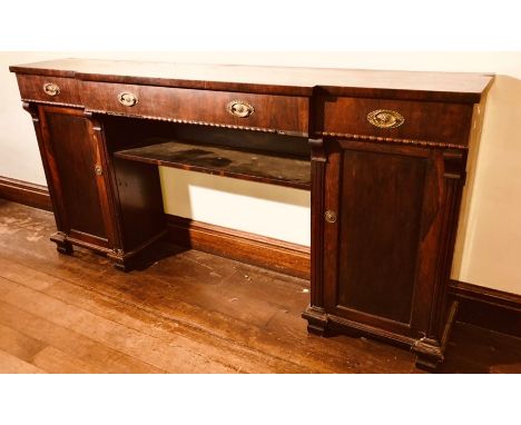 An early Victorian rosewood breakfront twin pedestal sideboard, circa 1840, shaped slight oversailing top above twin drawers 