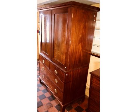 A George IV mahogany linen press, circa 1820, out swept moulded cornice enclosed by moulded panel doors previously fitted wit