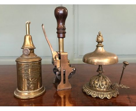 Vintage brass desk equipment, to include a spring operated desk stamp, a summons bell and a Pigeon Lampe, height of stamp 22c