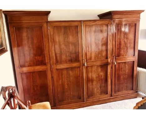 A Victorian mahogany inverted breakfront compactum wardrobe, circa 1860, twin out swept cornice on four panel doors, twin ped